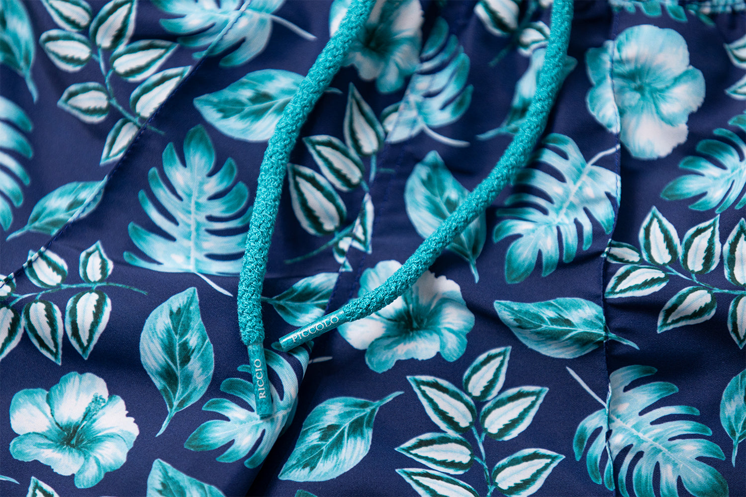 Detail of the PALAWAN tropical motif, signature front seam and drawstring craftsmanship by Piccolo Riccio.