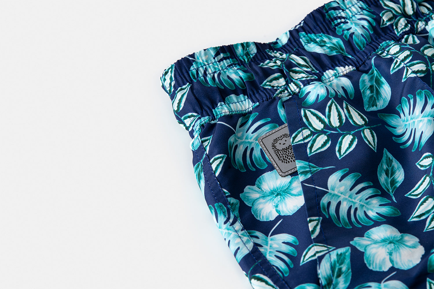 Detail of the discreetly integrated Piccolo Riccio signature within the front pocket of the PALAWAN edition.