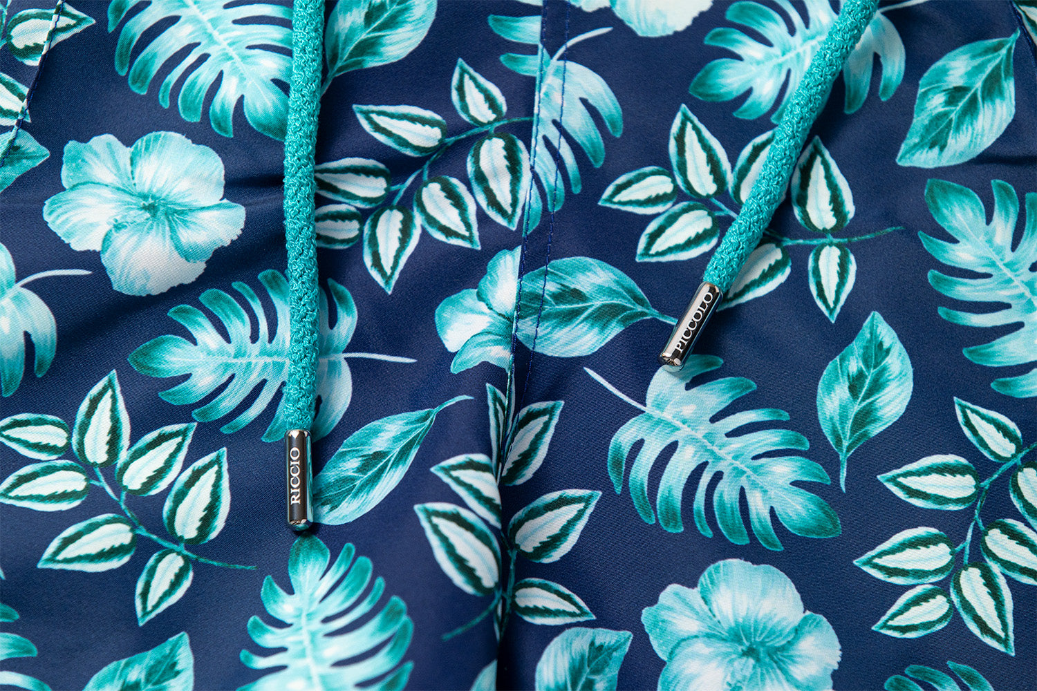 Detail of the PALAWAN floral motif, signature front seam and drawstring craftsmanship by Piccolo Riccio.
