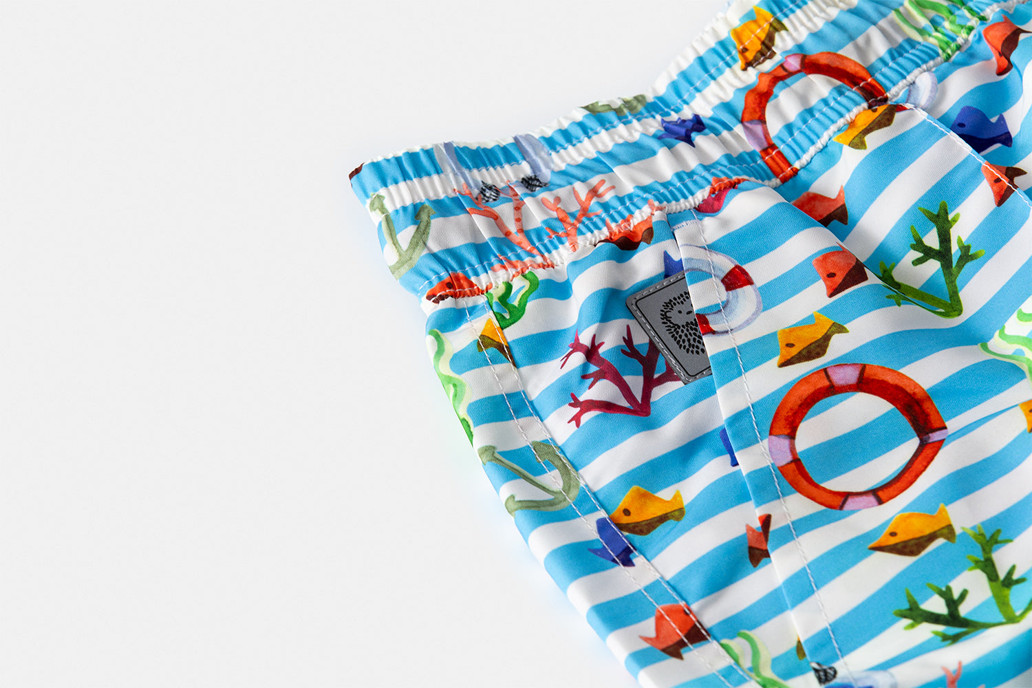 Detail of the discreetly integrated Piccolo Riccio signature within the front pocket of the KAI edition.