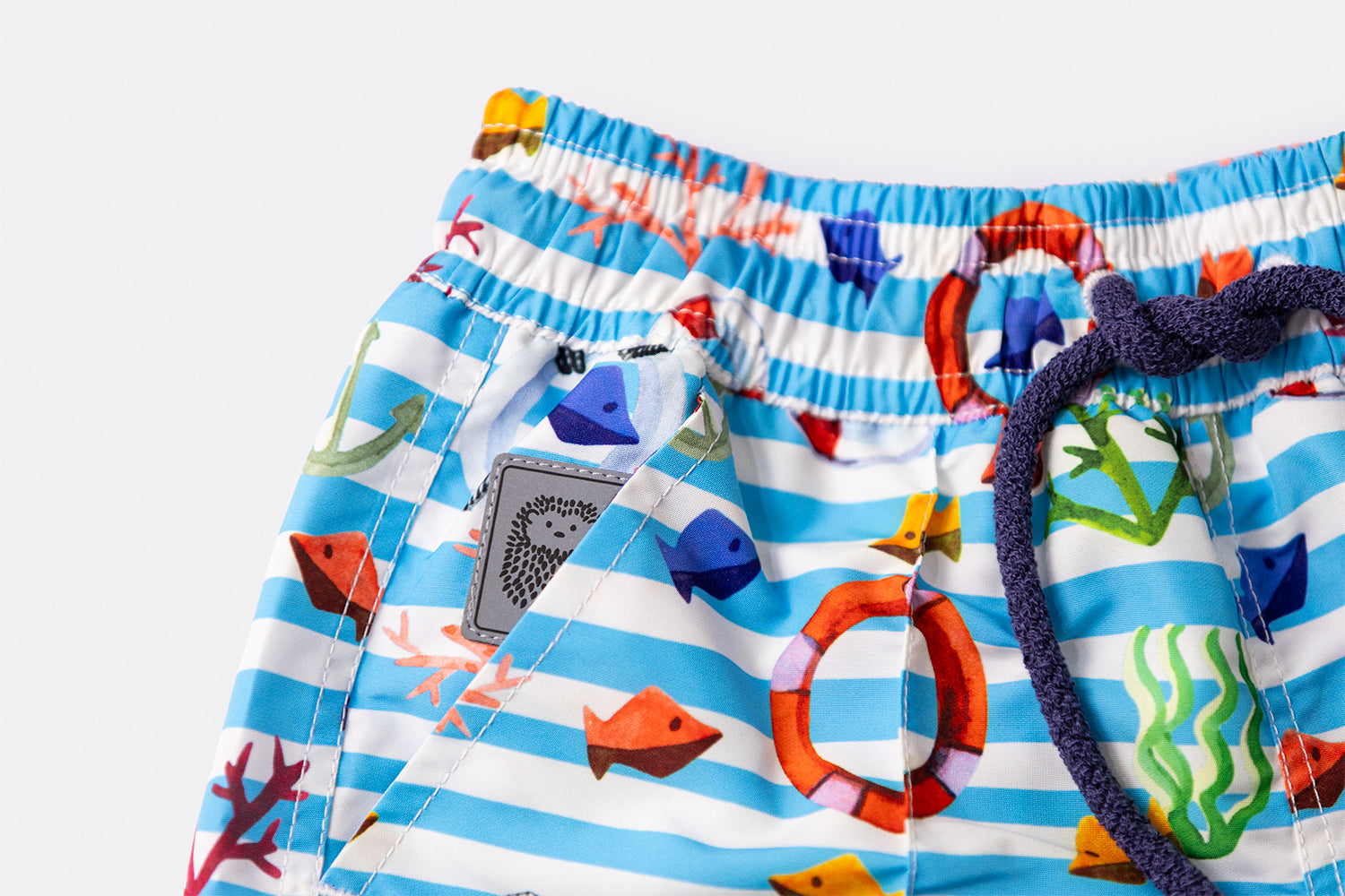 Detail of the discreetly integrated Piccolo Riccio signature within the front pocket of the KAI Children's Edition.