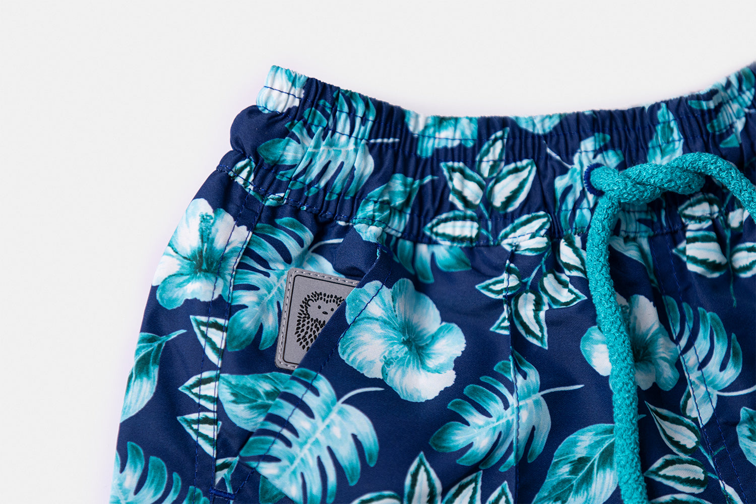 Detail of the discreetly integrated Piccolo Riccio signature within the front pocket of the PALAWAN Children's Edition.