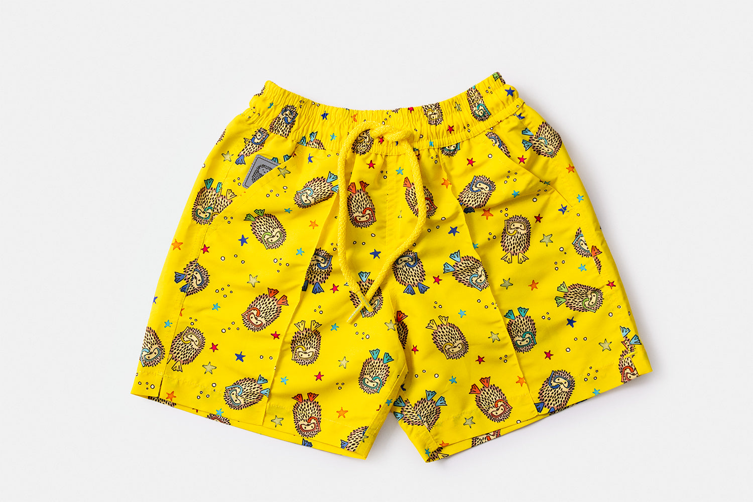 Front view of the YAKUSHIMA Children's Edition luxury swim shorts featuring the iconic hedgehog motif and signature silhouette by Piccolo Riccio.