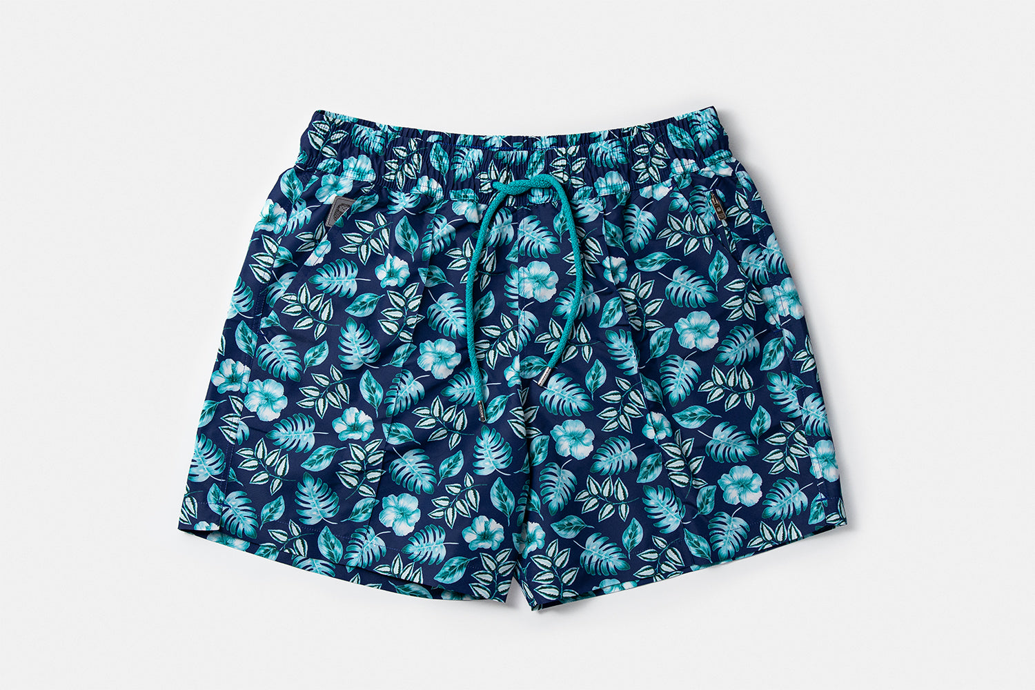 Front view of the PALAWAN luxury swim shorts featuring the tropical botanical motif and signature silhouette by Piccolo Riccio.