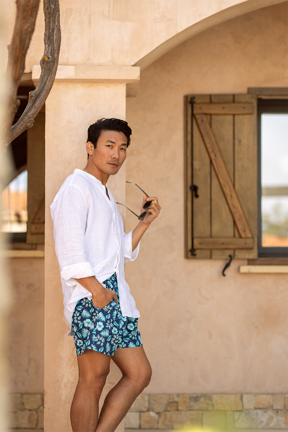 Model wearing the PALAWAN luxury swim shorts crafted in Spain by Piccolo Riccio.