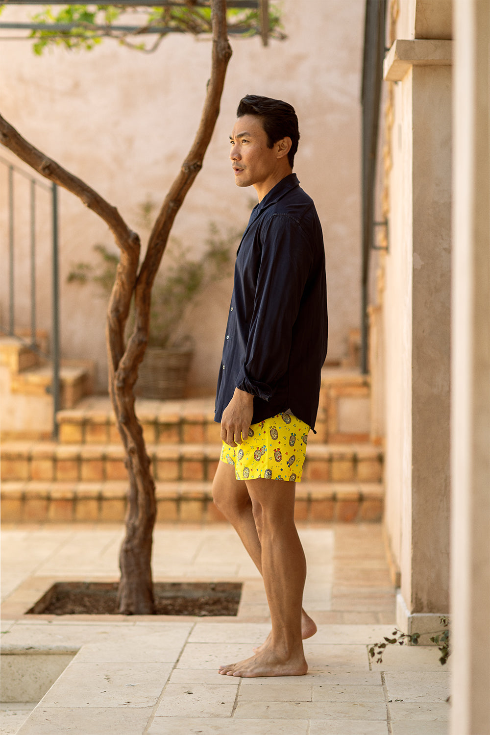 Model wearing the YAKUSHIMA flagship luxury swim shorts by Piccolo Riccio crafted in Spain.